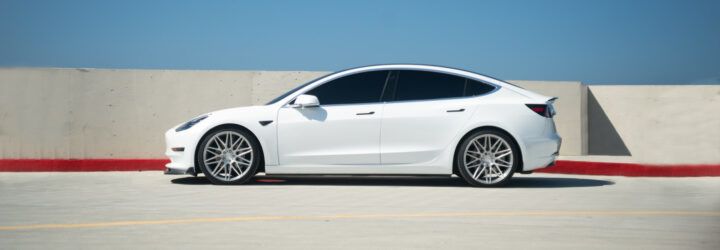 white Tesla in a parking lot