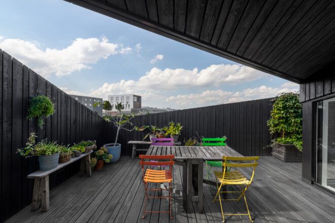 wood patio table with colorful chairs
