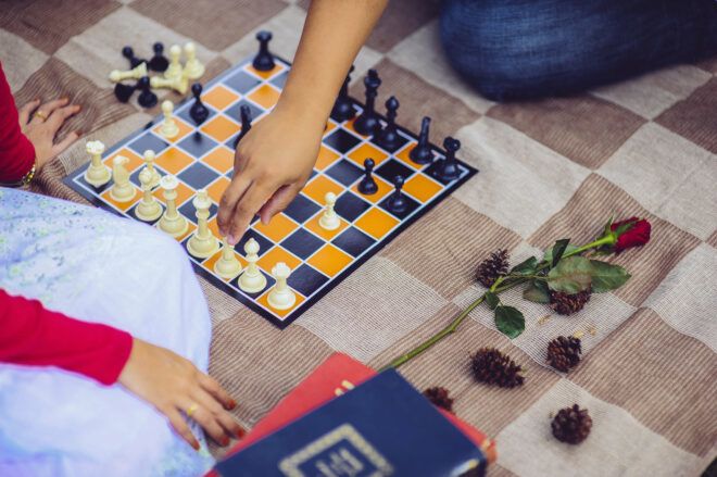 hands grabbing chess pieces