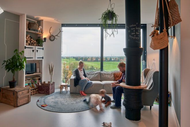 family sitting and playing together in a small living room