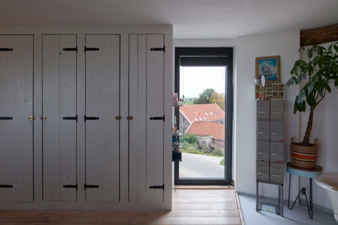 wall of closets next to tall narrow window