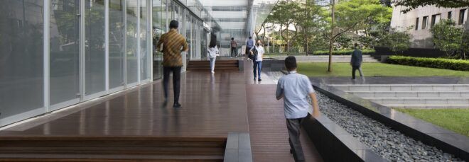 People milling around a tiered outdoor space near the building.