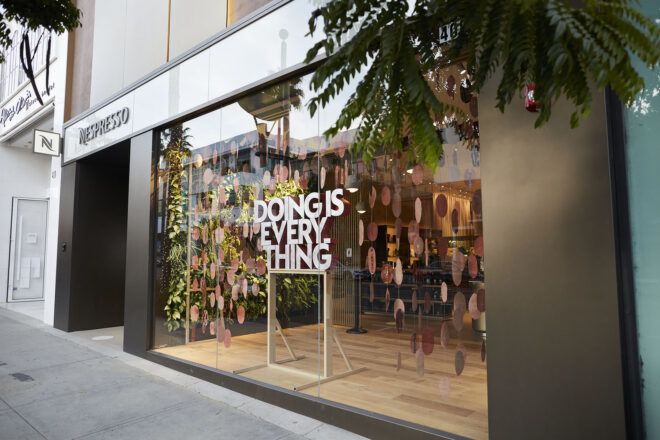 A streetview of a window display that reads "doing is everything."