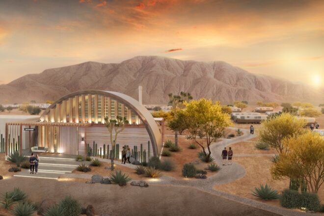 rendering of Airstreams behind rounded buildings surrounded by mountains and desert at sunset