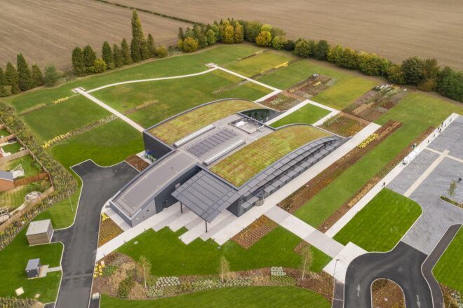 A bird's-eye view of an office complex with a green roof.