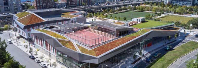 A bird's-eye view of a sprawling green community campus in the city.