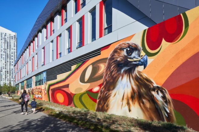 A mural of a bird on the side of a building.