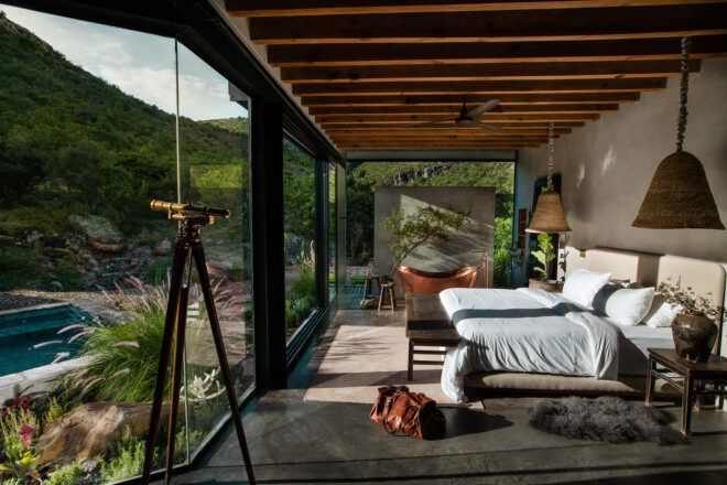 large bed facing wall of glass