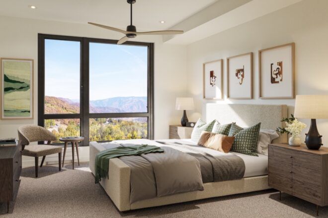 large white and gray bed next to wall of glass