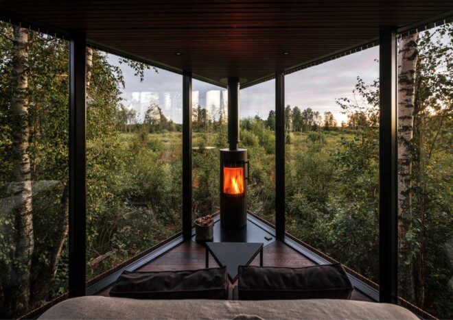 fireplace in corner between two glass walls