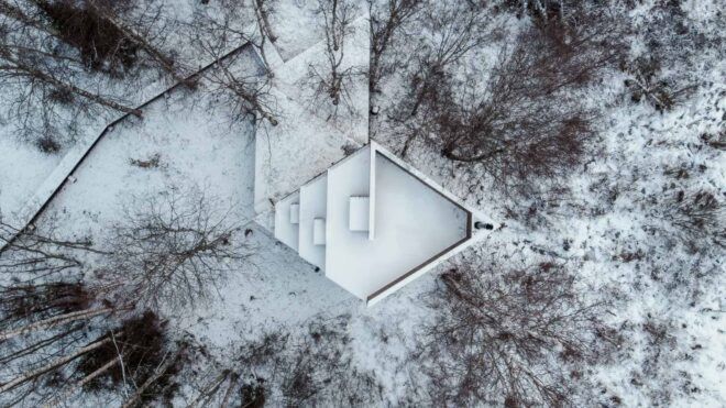 aerial view of diamond-shaped cabin in snowy landscape