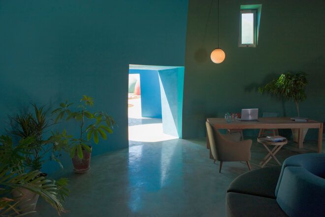 wood desk in room with blue and green walls