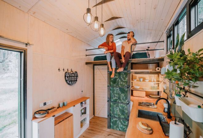 two people sitting on loft above a kitchen