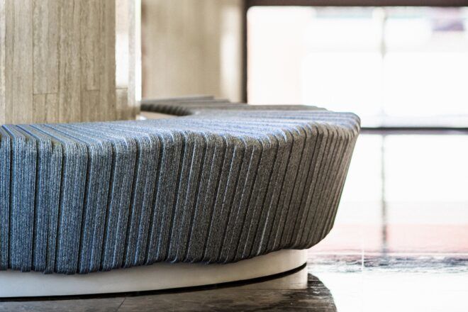 A curving bench in a blue-gray color.