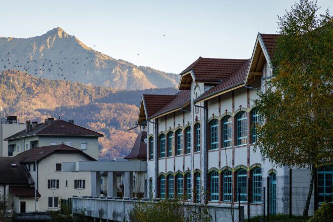old white gabled building in mountainous landscape
