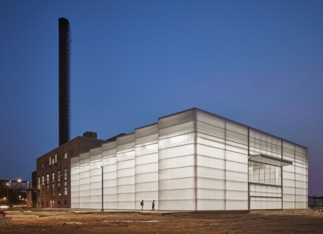 A streetview of the polycarbonate facade lit up from within.