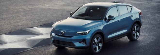 gray electric vehicle driving on road