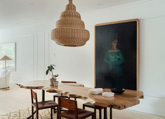 raw edge wood dining table beneath wood pendant light