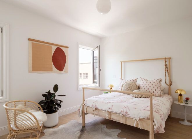 wood-framed bed in white room