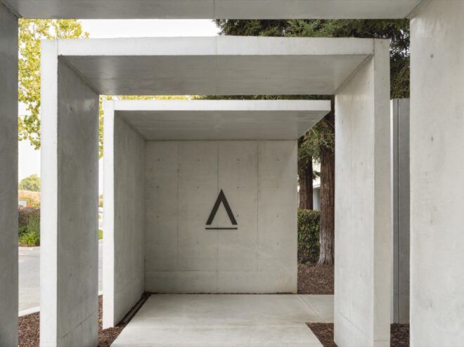 white rectangular archways leading to a building