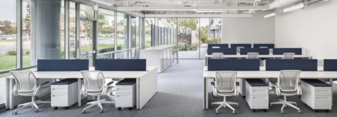 white desks in room with glass walls