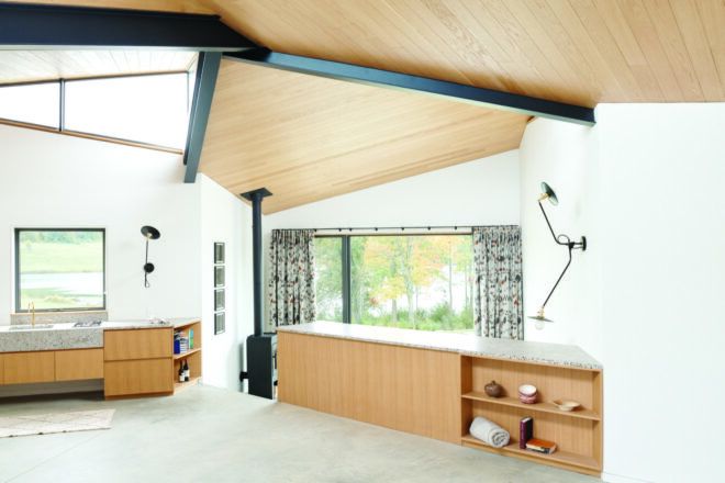 A room with white walls and light-colored wood cabinets and ceiling.
