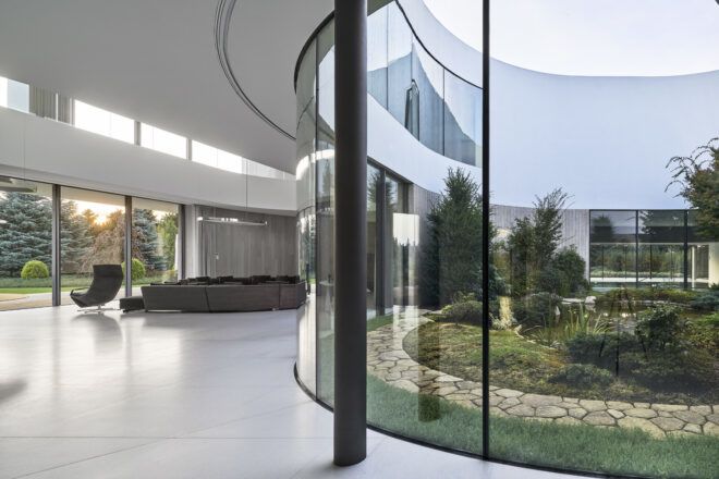 gray living room furniture near curved glass wall