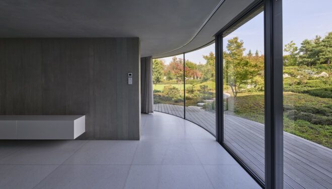 gray room with one glass wall leading to outdoor patio