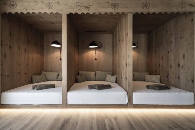 three twin beds built into a wood wall