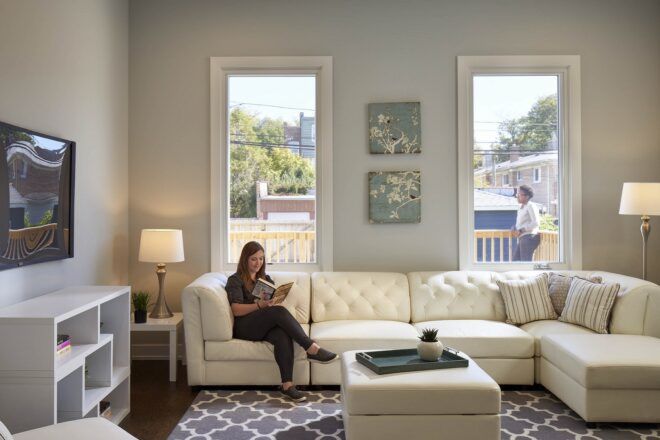 person sitting on tufted white sofa