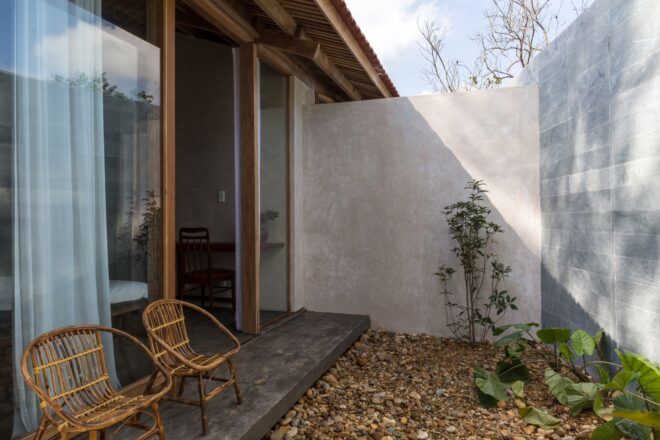 A patio area surrounded by walls, with a small rock garden.