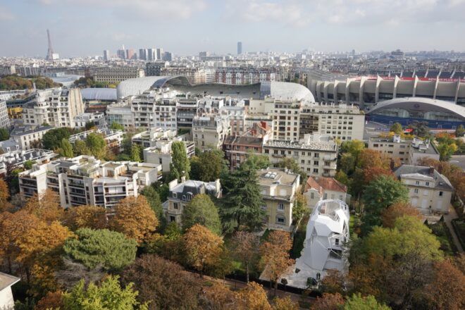 long white home surrounded by older buildings