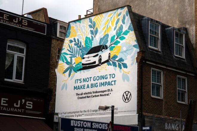 A large painted VW ad on the side of a building, reading "It's not going to make a big impact."