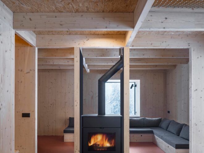 L-shaped sofa around a central wood-burning stove