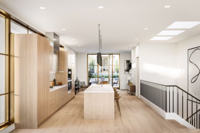 kitchen with long island facing wall of light wood cabinets