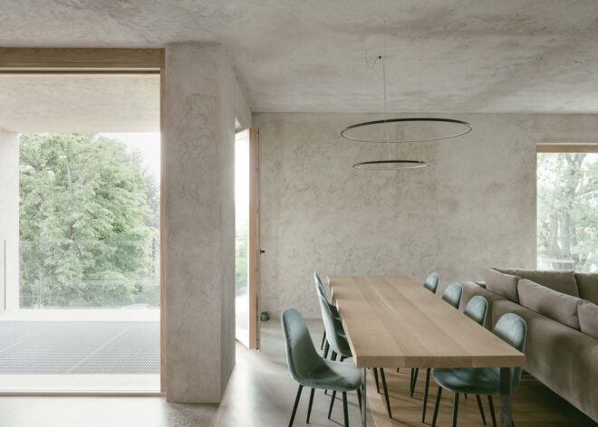 long wood dining table near full-height windows