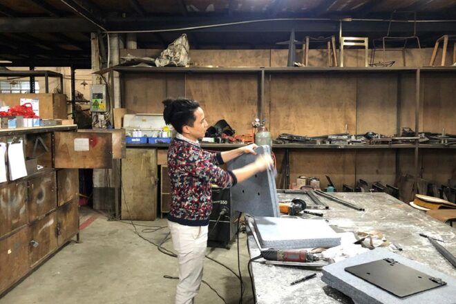 A person working on a bench in a studio setting.
