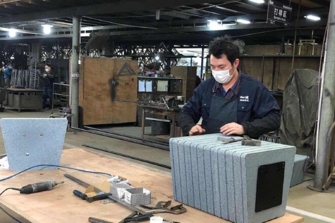 A person working on a bench in a studio setting.