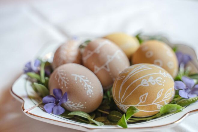 naturally dyed eggs with white floral drawings