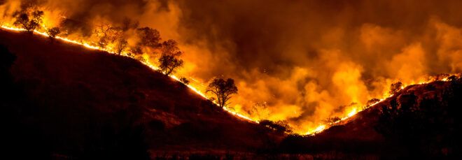 Woolsey fire burning along hills in California