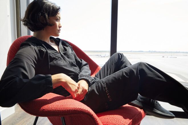 person lounging while wearing black jumpsuit