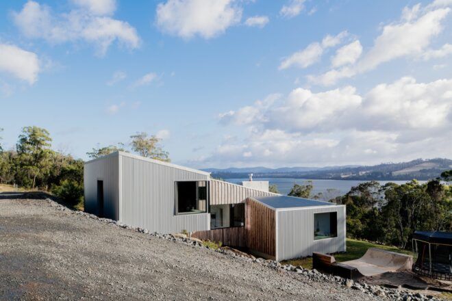 gray home with sloped roof covered in solar panels