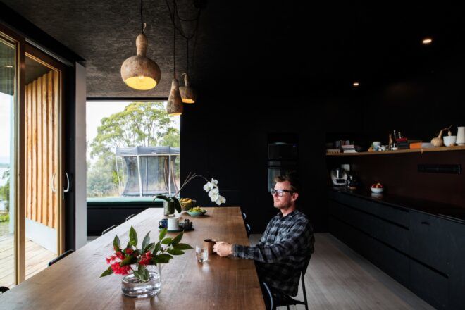 person sitting at long wood dining table