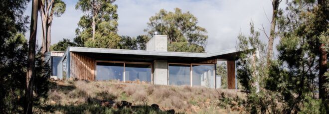 metal, concrete and wood home on a hill