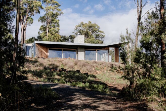 metal, concrete and wood home on a hill