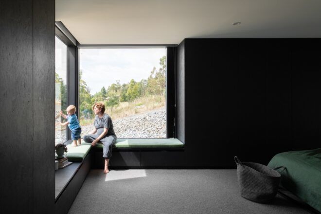person and baby sitting on window seat