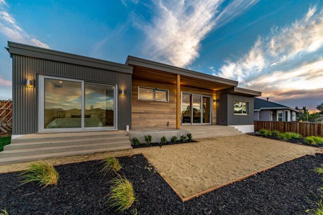 wood and gray home at sunset