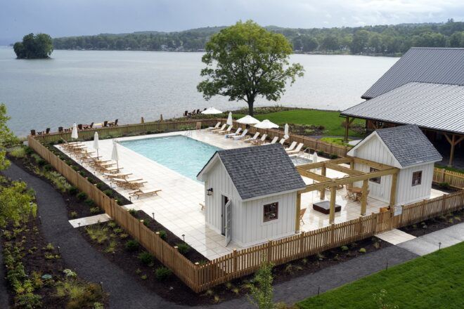 An overhead view of a pool area by the lakeside.