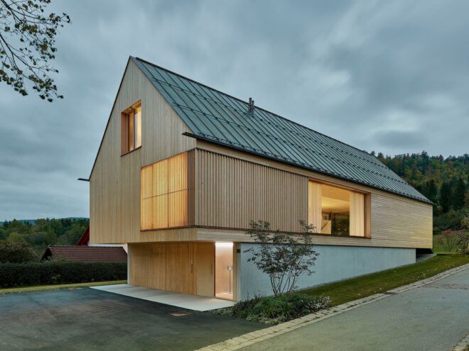 The back of the home, showing a facade of light-toned wood.