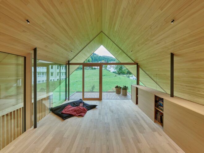 An interior loft with light-toned wood ceiling, floor and walls.
